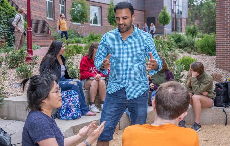 three people having a discussion outside